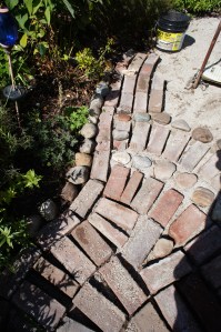 The stones and meandering bricks create a lovely sense of movement.